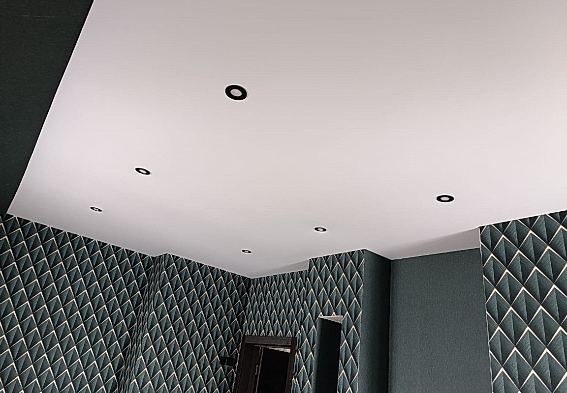 Коридор с теневым профилем по периметру и матовым натяжным потолком и черным светильниками.